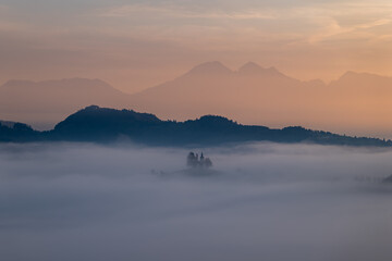 Cerkev Sveti Tomaž (St. Thomas Church) near Škofja Loka, Slovenia. Misty morning and sunrise
