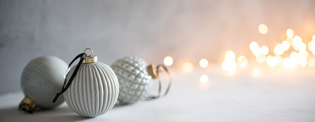 Scandinavian style pastel colored baubles with Christmas bokeh lights