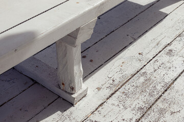 Details of a white, beach pavilion on an empty beach.