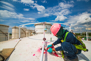 Male worker inspection process color red paint weld cleaning white developer at the with carbon pipeline