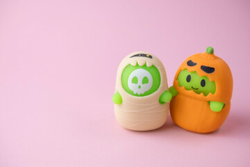 children's monsters for Halloween on pink and orange background , the concept of a children's holiday