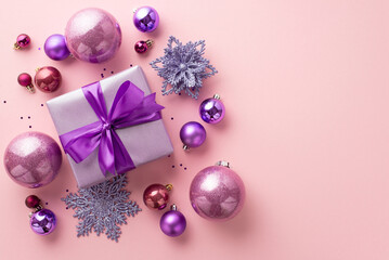New Year concept. Top view photo of big purple present box with ribbon bow pink violet baubles...