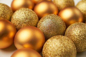 selective focus on golden Christmas balls with different textures and glitters