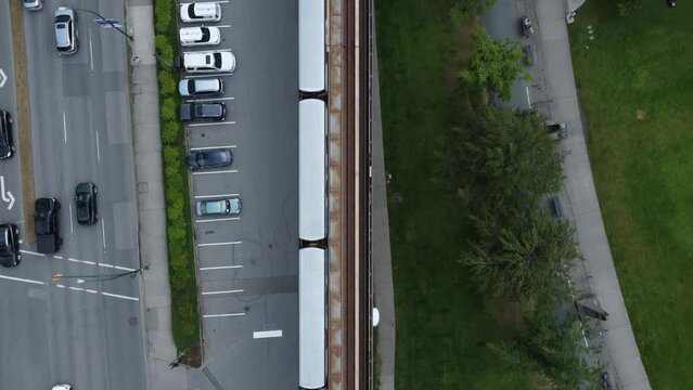Aerial view of a Skytrain subway and cars on the street in Vancouver downtown