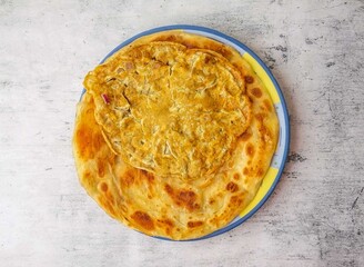 anda paratha or omelet paratha served in a plate isolated on background top view of indian and...