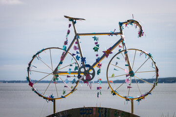 Racing bike decorated with garlands. In the background the sea