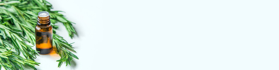 Rosemary essential oil in a small bottle. Selective focus.