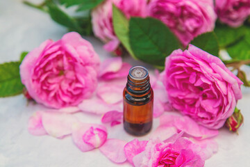 Obraz na płótnie Canvas Rose essential oil in a bottle. Selective focus.