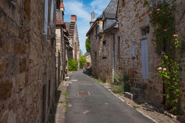 a street with old limestone houses in Turenne france