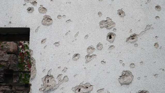 Bullet holes in the wall on the front line. Remnants of the war in Bosnia and Herzegovina.
