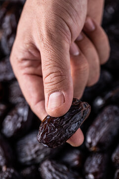 Crop person demonstrating date medjoul