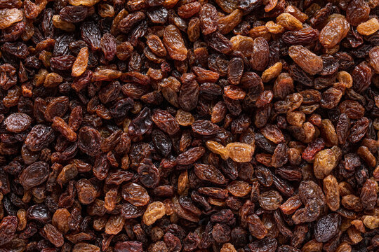 Pile of raisins scattered on table