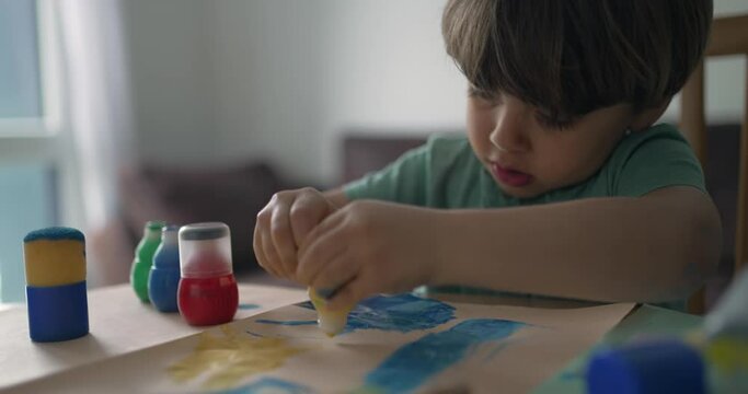 One little boy using coloring brush to paint at home. Child creativity artistic activity at home. Kid coloring