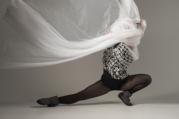 Ballerina Dancing with Silk Fabric, Modern Ballet Dancer with Waving white fabric, Gray Background....