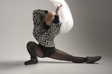 Ballerina Dancing with Silk Fabric, Modern Ballet Dancer with Waving white fabric, Gray Background. With text on sweater DREAMS OF