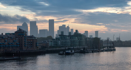 Fototapeta na wymiar View of River Thames and City Skyline during dramatic sunrise. City of London, United Kingdom. Travel Destination