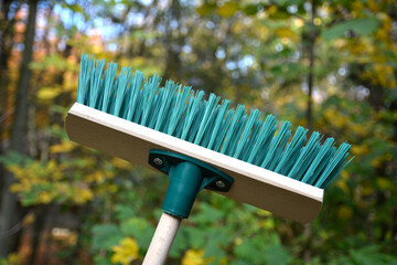 Green plastic broom .