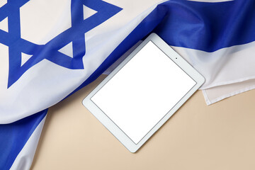 Modern tablet computer and flag of Israel on color background