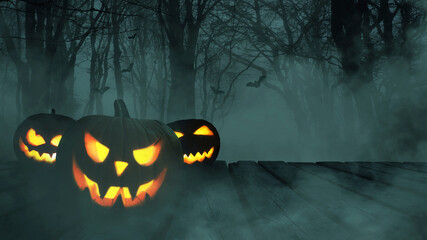 Three scary glowing pumpkins on a wooden table in a night forest with fog and bats in the dark....