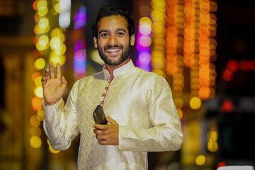 Young Boy saying hi wearing traditional dress and beautiful background