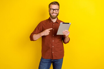 Photo of clever good mood man blond beard dressed burgundy shirt directing at tablet sale discount isolated on yellow color background