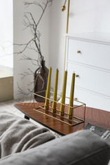 Stylish holder with candles on wooden table