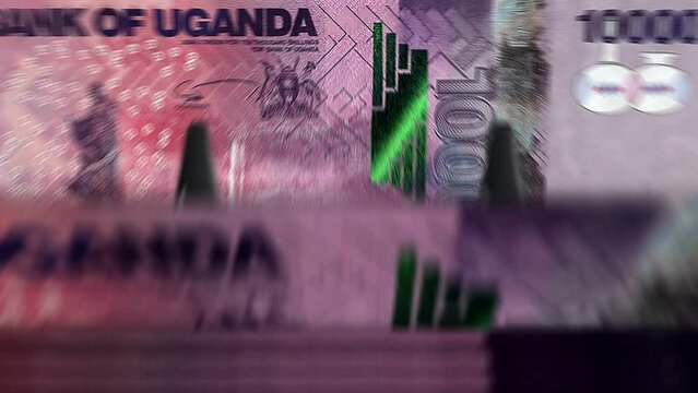 Uganda money Shilling money counting machine with banknotes. Quick UGX currency note down rotation. Business and economy. Concept loopable and seamless background.