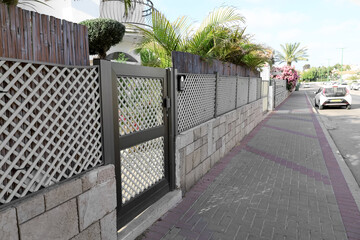 View of fence with metal door outdoors