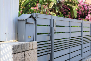 View of metal mailbox near fence outdoors