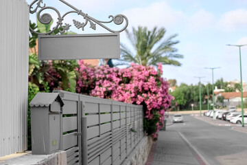 View of metal mailbox near fence outdoors