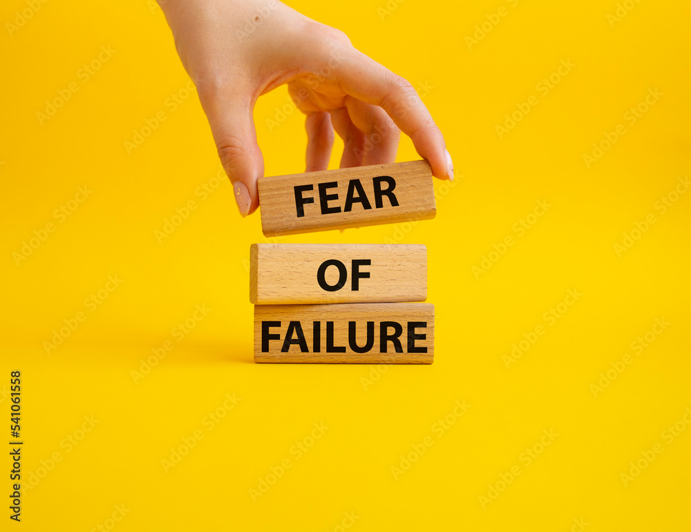 Fototapete fear of failure symbol. concept words fear of failure on wooden blocks. beautiful yellow background.