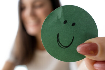 smiling woman holding a smiley cartoon