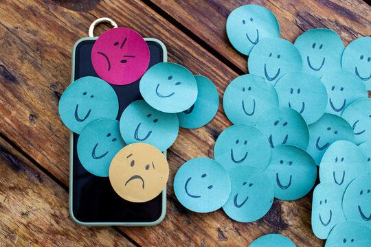 concept of emotions or rating in social networks and technology, smiles, expressions, feelings, anxiety, sadness, depression. - top view