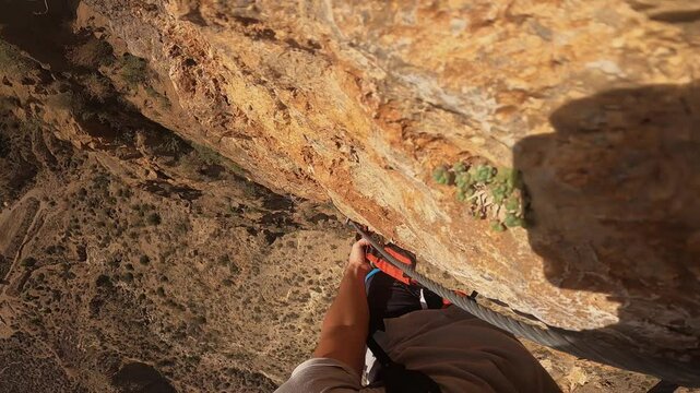 point of view, climbing a section of via ferrata, changing sections with the carabiner
