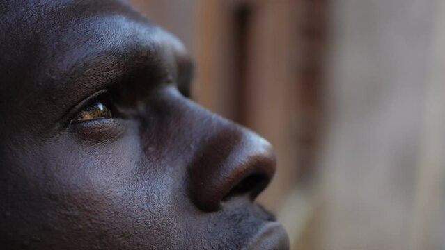 Migration, refugee concept. Young blac man looking the sky