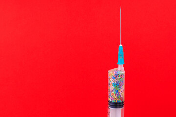 A classic disposable syringe filled with symbolic hearts. Love concept. Background with copy space....