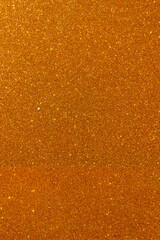 Obraz premium Background with sparkles. Backdrop with glitter. Shiny textured surface. Vertical image. Strong orange