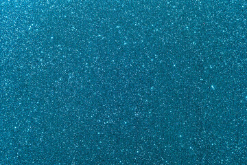 Background with sparkles. Backdrop with glitter. Shiny textured surface. Dark cyan