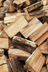 Firewood. Stack of firewood close up, wooden background. Chopped wood for fireplace heating, alternative to gas and electricity. Lumber pattern, log