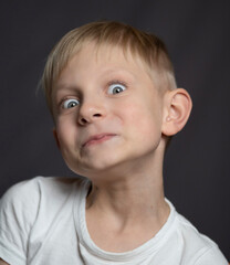 Studio portrait of  a blue-eyed blonde caucasian boy