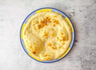 Tandoori naan or khamiri roti served in a plate isolated on background top view of indian and pakistani desi food