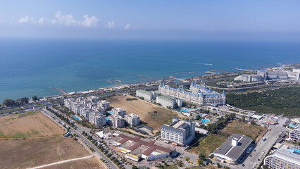 Fototapeta premium Aerial drone photo of the beautiful town of Alanya, a resort town on Turkey’s central Mediterranean coast showing a hotel and vacation holiday resort from above in the summer time.