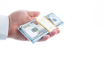 A pack of dollars in a hand on a white background.