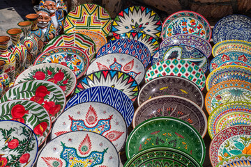 Decorative ceramic plates with traditional uzbek ornament in the street market of Bukhara. Uzbekistan