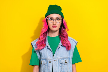 Portrait of nice cute lovely gorgeous girl with wavy hairstyle wear green t-shirt look at camera isolated on yellow color background