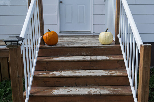 Two Pumpkins at Top of Stairs