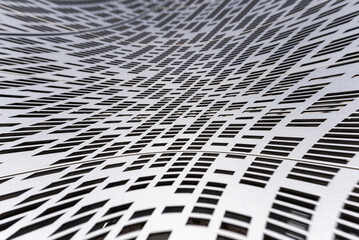 Curved metal surface with perforated holes, background.