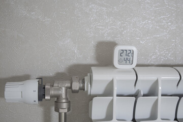 The thermometer shows a comfortable temperature in the house in winter against the background of...