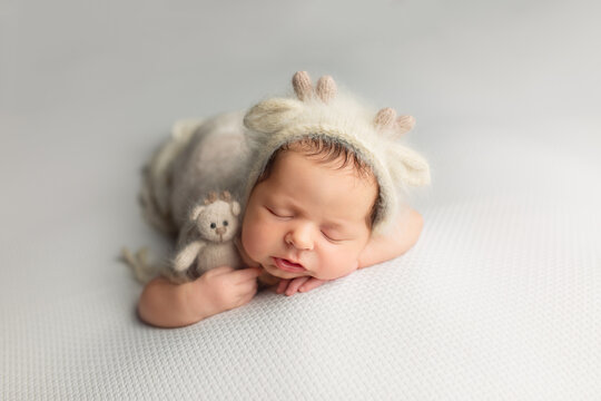the first photo session of a newborn baby. the kid in the cap the deer. newborn
