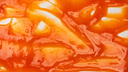 Red sauce splashes as background.